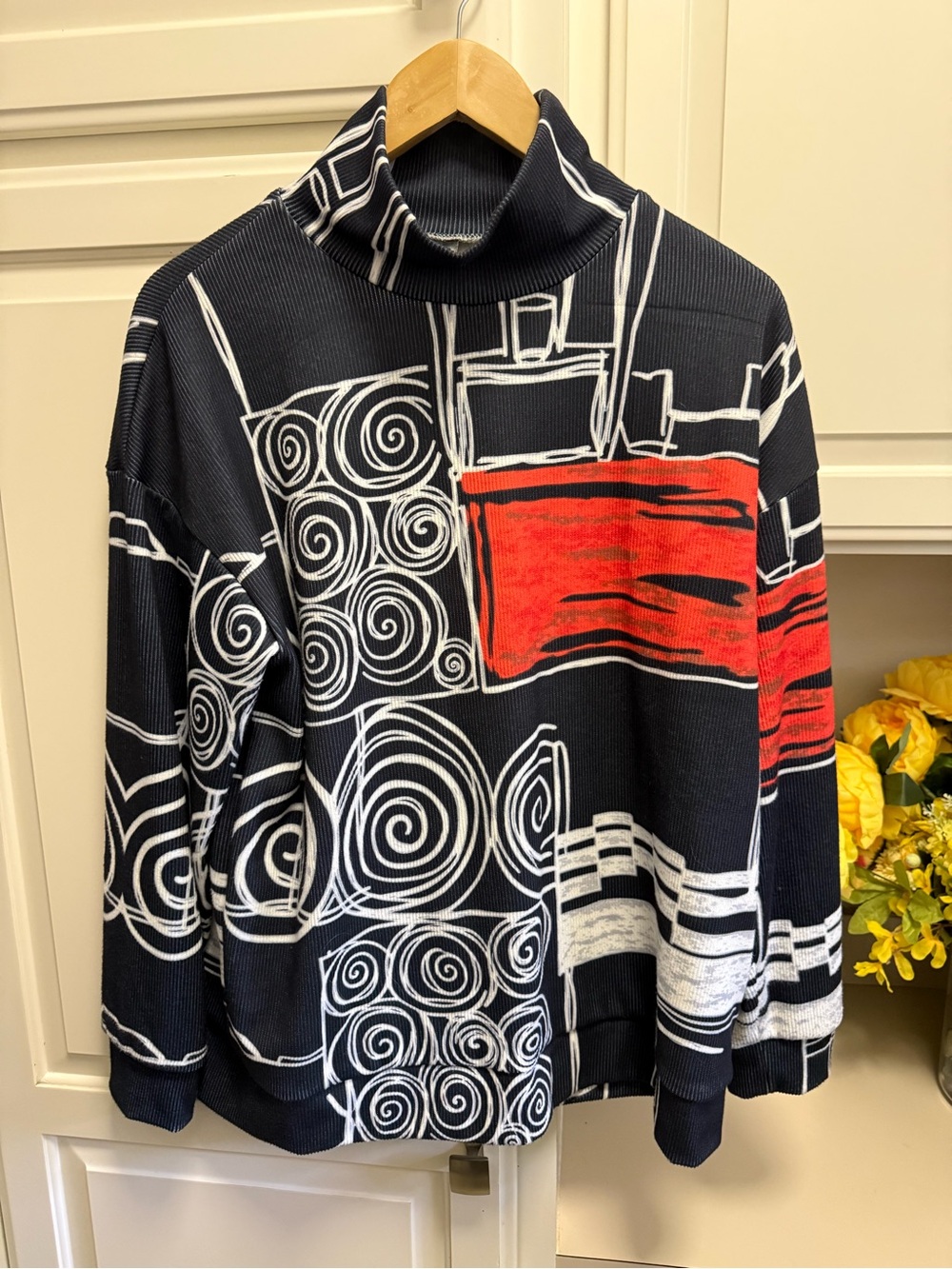 Black Turtleneck Sweater with White Graphic and Red Accents